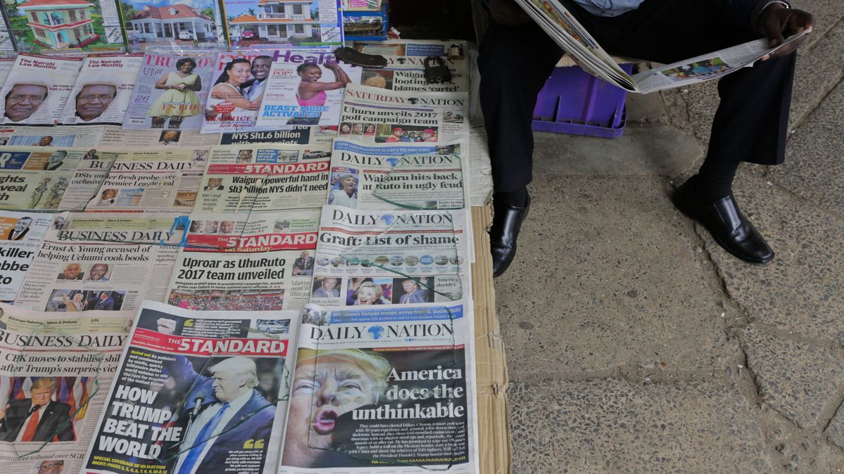 A Kenyan newspaper vendor reads a newspaper, Nairobi, Kenya, 10 November 2016 